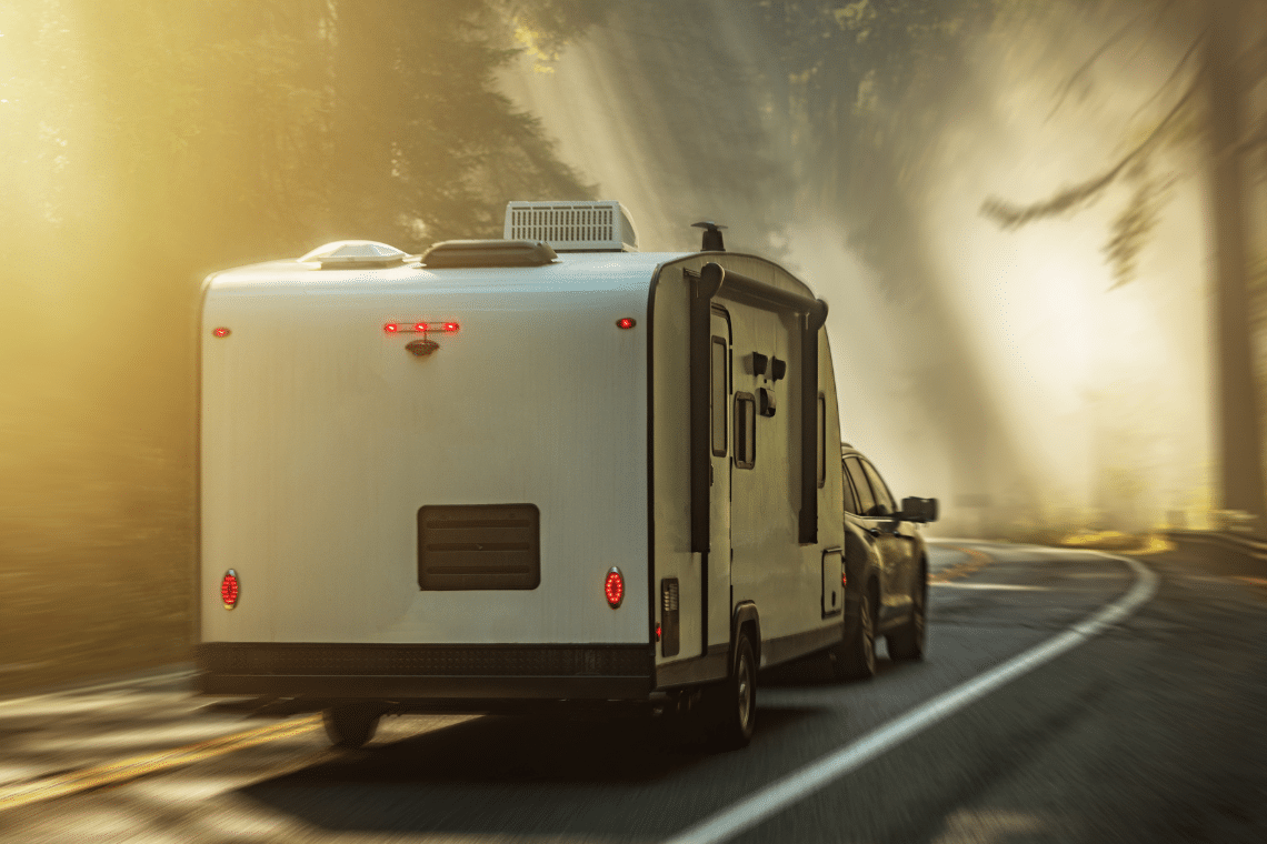 Caravan being towed by a car along the road to Hogleaze storage facility
